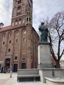 A statue of Nicolaus Copernicus in front of Toruń town hall